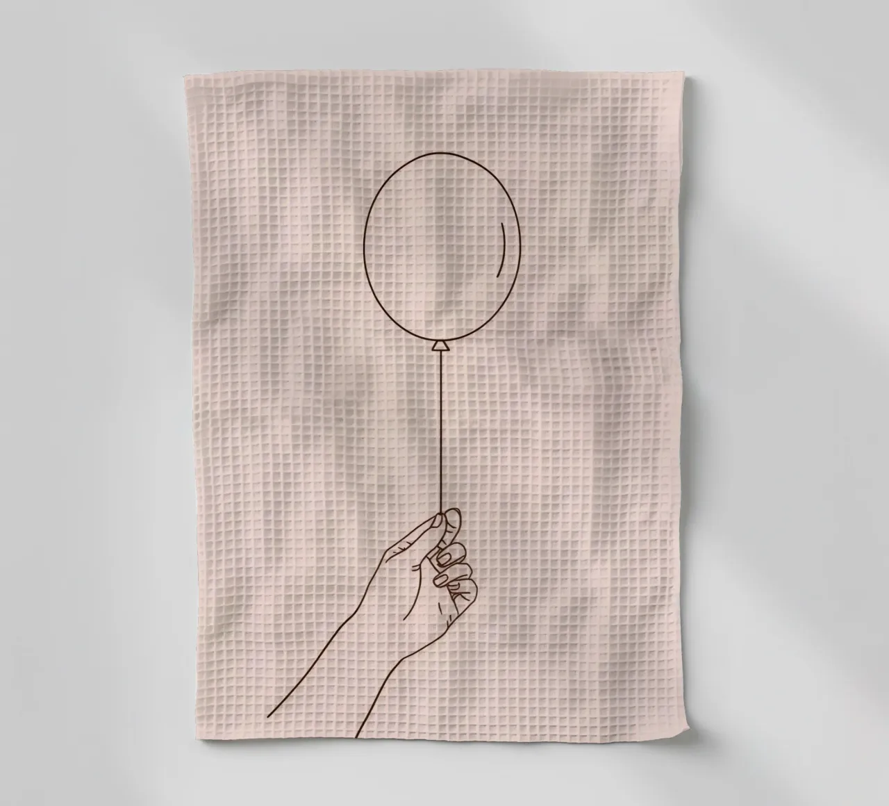Mano che tiene un palloncino singolo rosa pastello simboleggia la gioia canovaccio da cucina da DesignDoodle