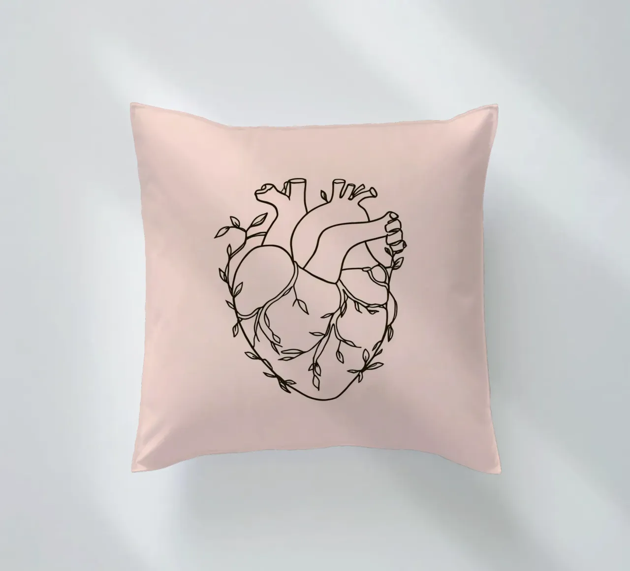 Artistic representation of a heart intertwined with plants decorative cushion by DesignDoodle