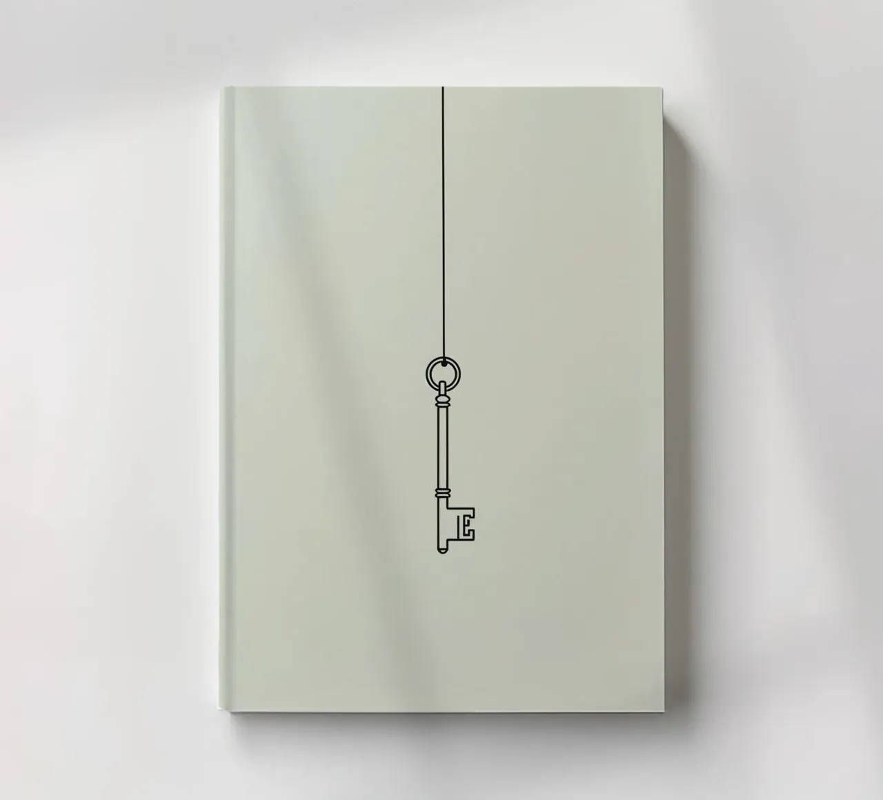 Clé suspendue à une ficelle sur fond de lumière carnet de notes de DesignDoodle