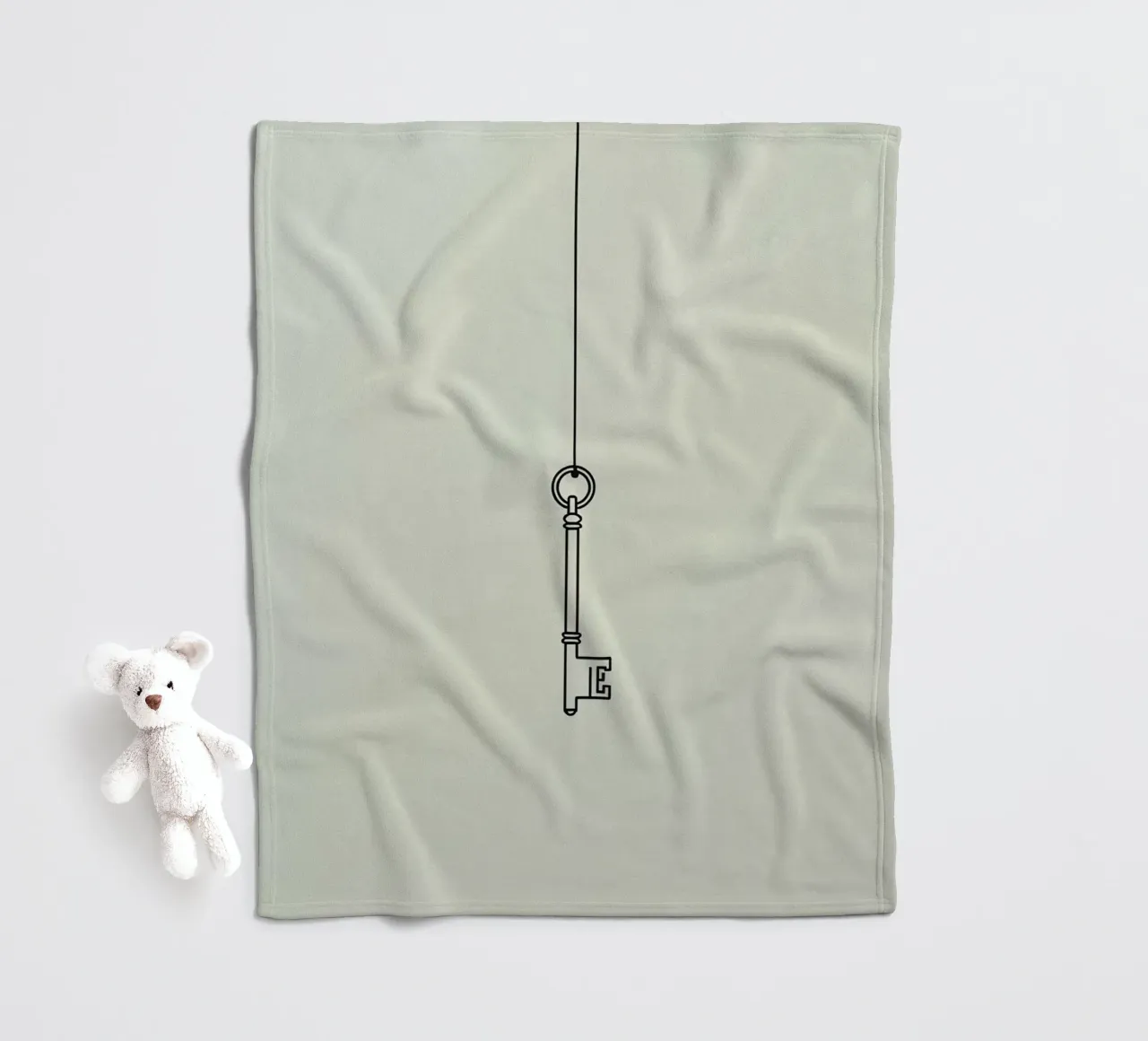 Key hanging from a string against a light backdrop fleece blanket by DesignDoodle