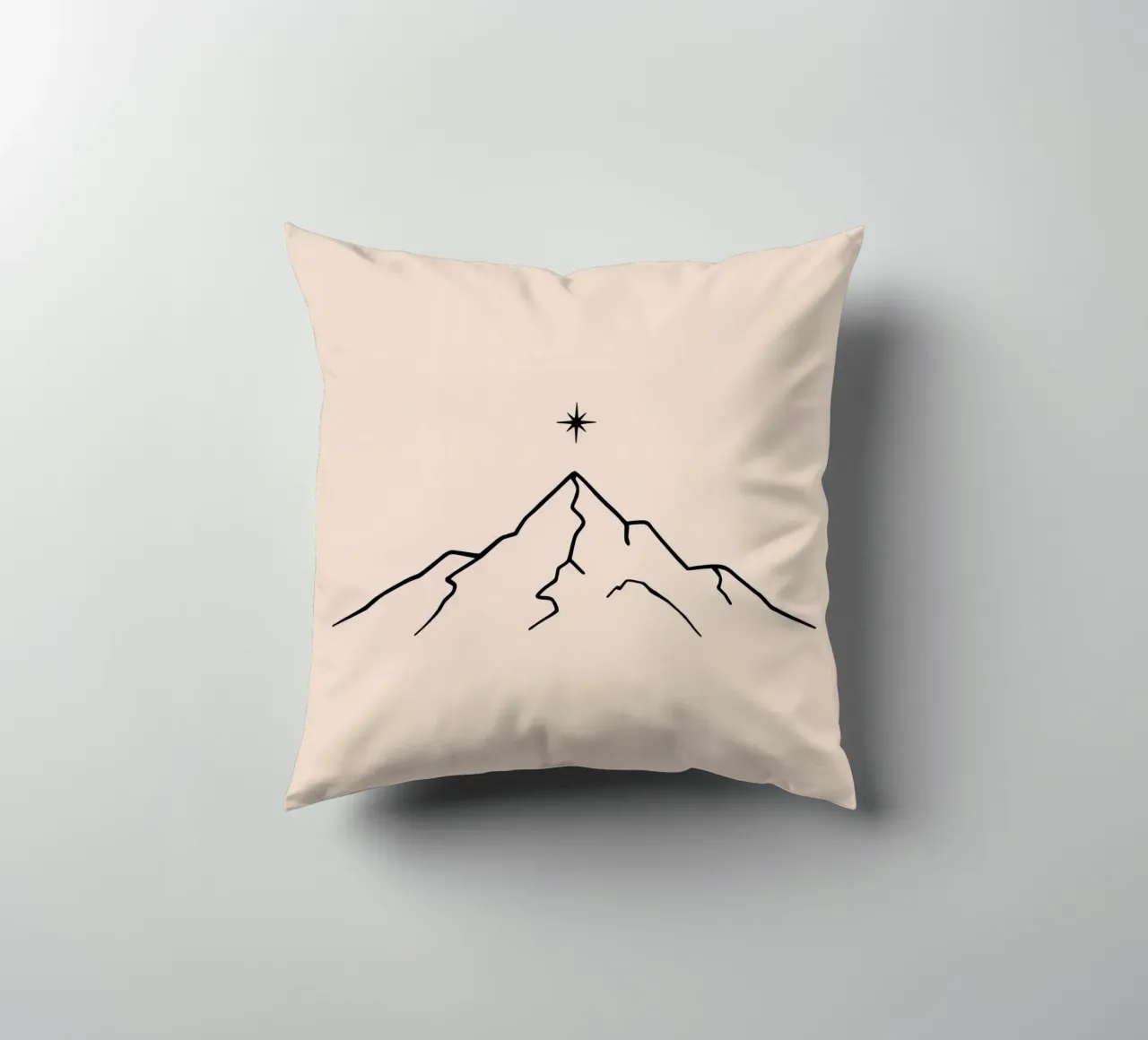 Mountain peak with a star above in a minimalist design decorative cushion by DesignDoodle