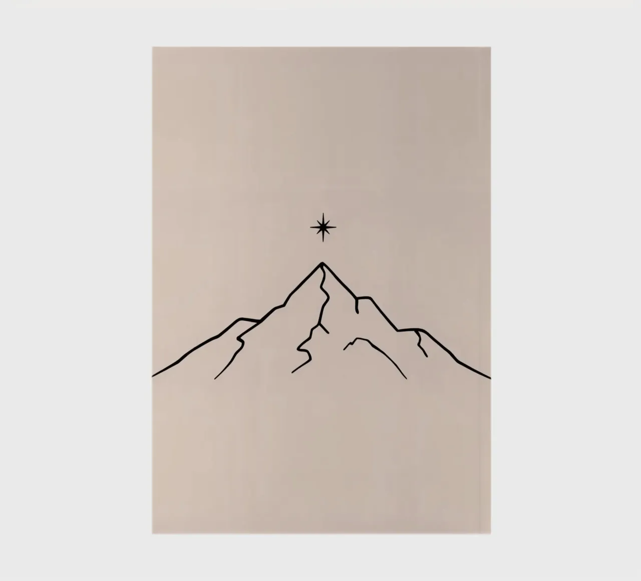 Mountain peak with a star above in a minimalist design notebook by DesignDoodle