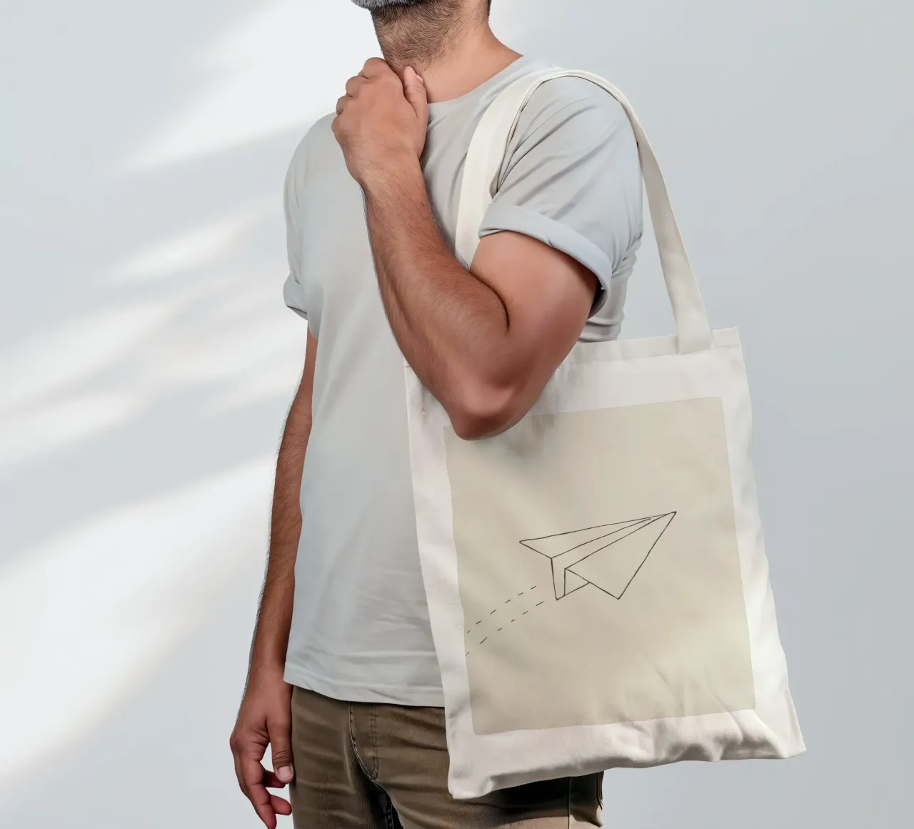 Paper airplane soaring through the air with trailing flight tote bag by DesignDoodle