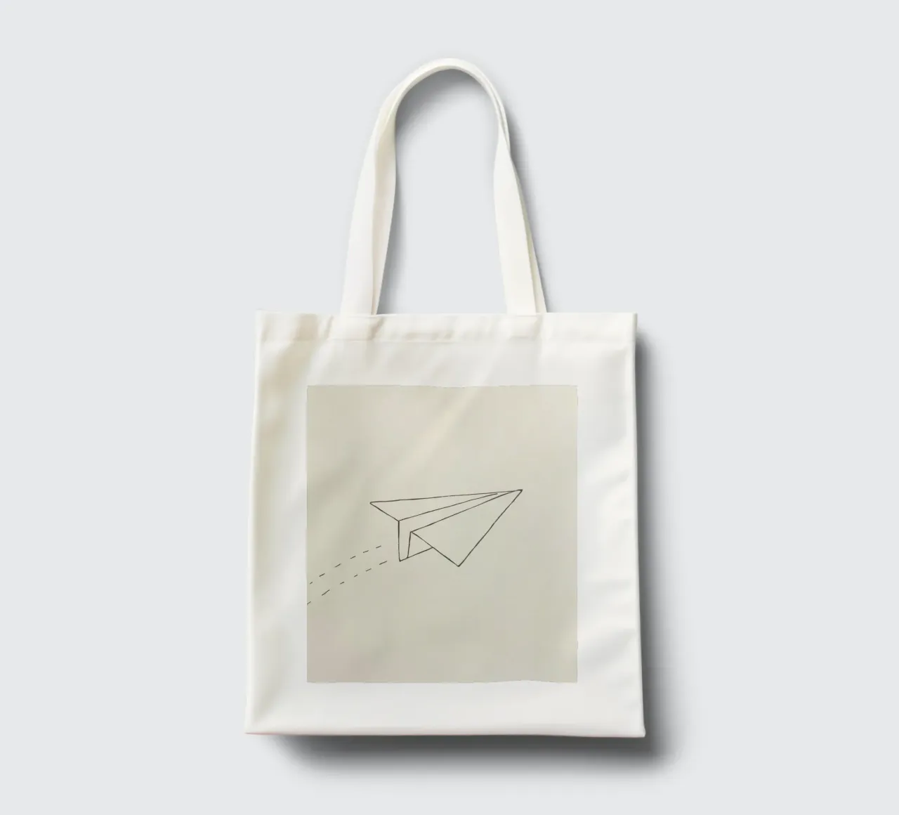 Paper airplane soaring through the air with trailing flight tote bag by DesignDoodle
