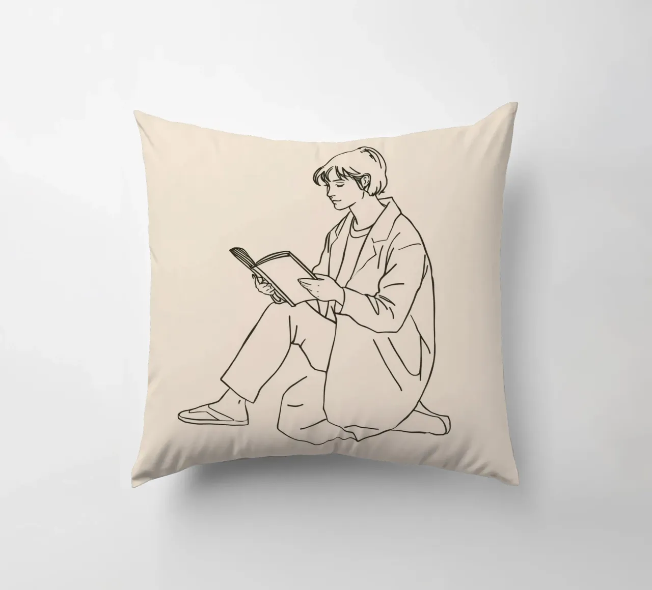 Person reading a book while sitting on the floor in a casual decorative cushion by DesignDoodle