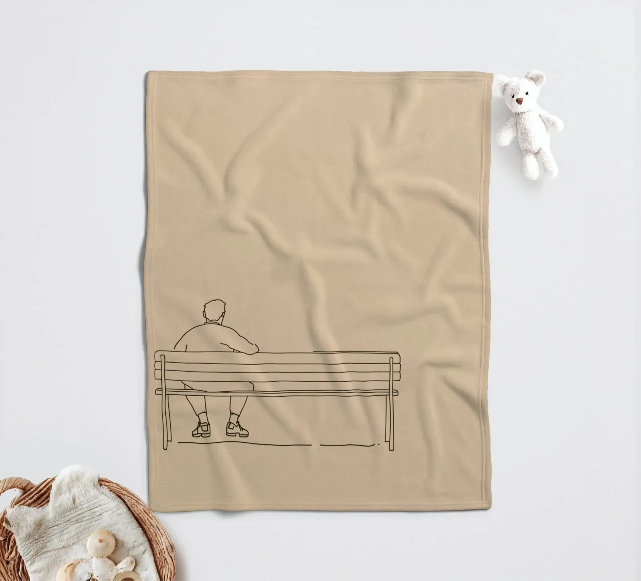Individual sitting quietly on a bench in a minimalist art fleece blanket by DesignDoodle