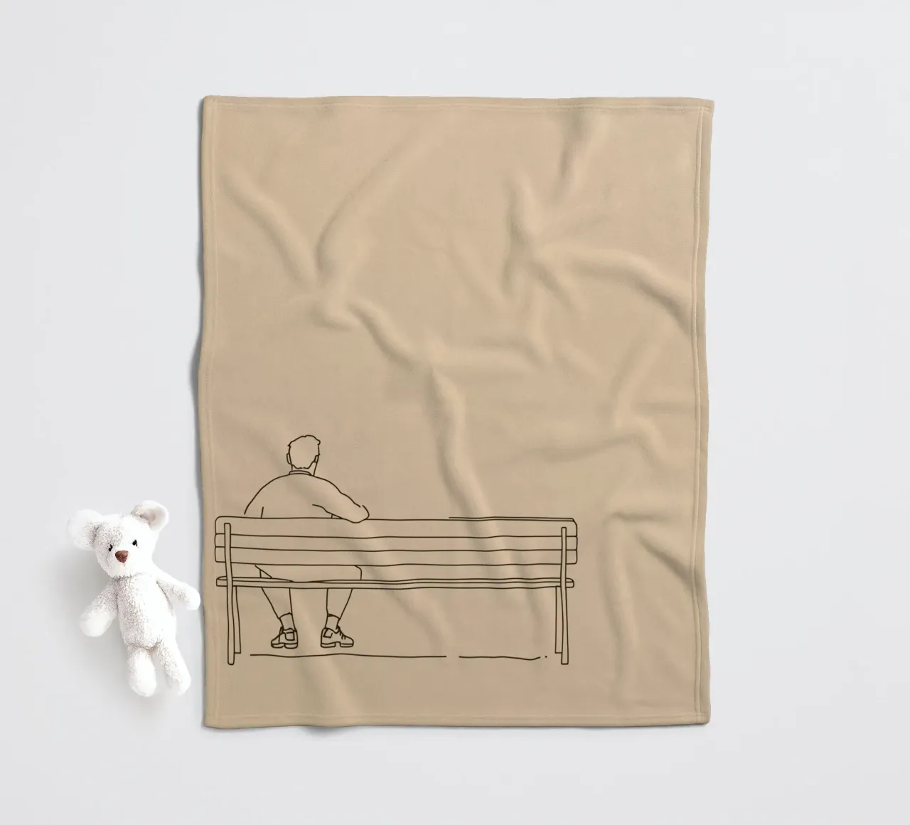 Individual sitting quietly on a bench in a minimalist art fleece blanket by DesignDoodle