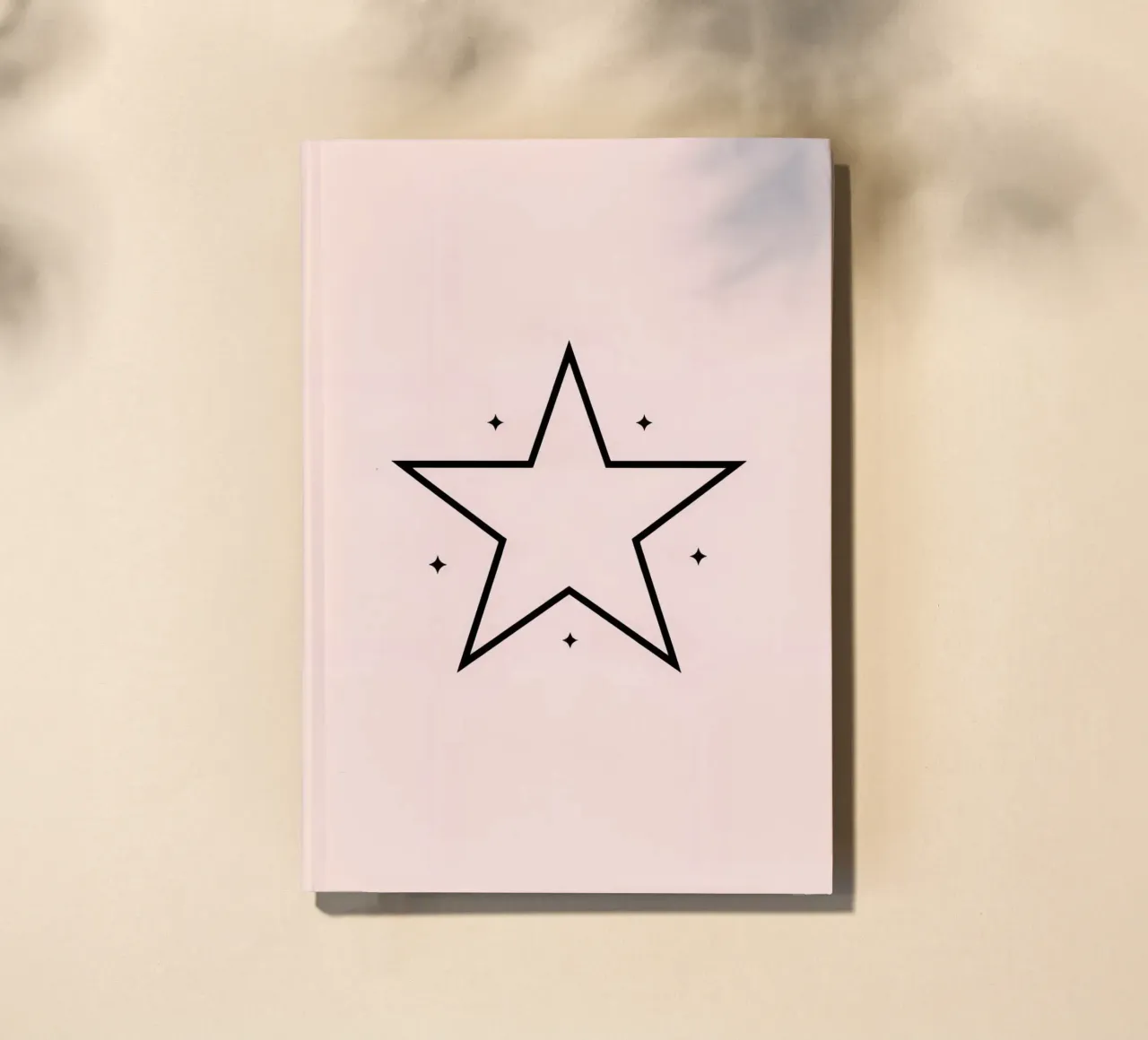 Minimalist black star design on a soft pink background notebook by DesignDoodle