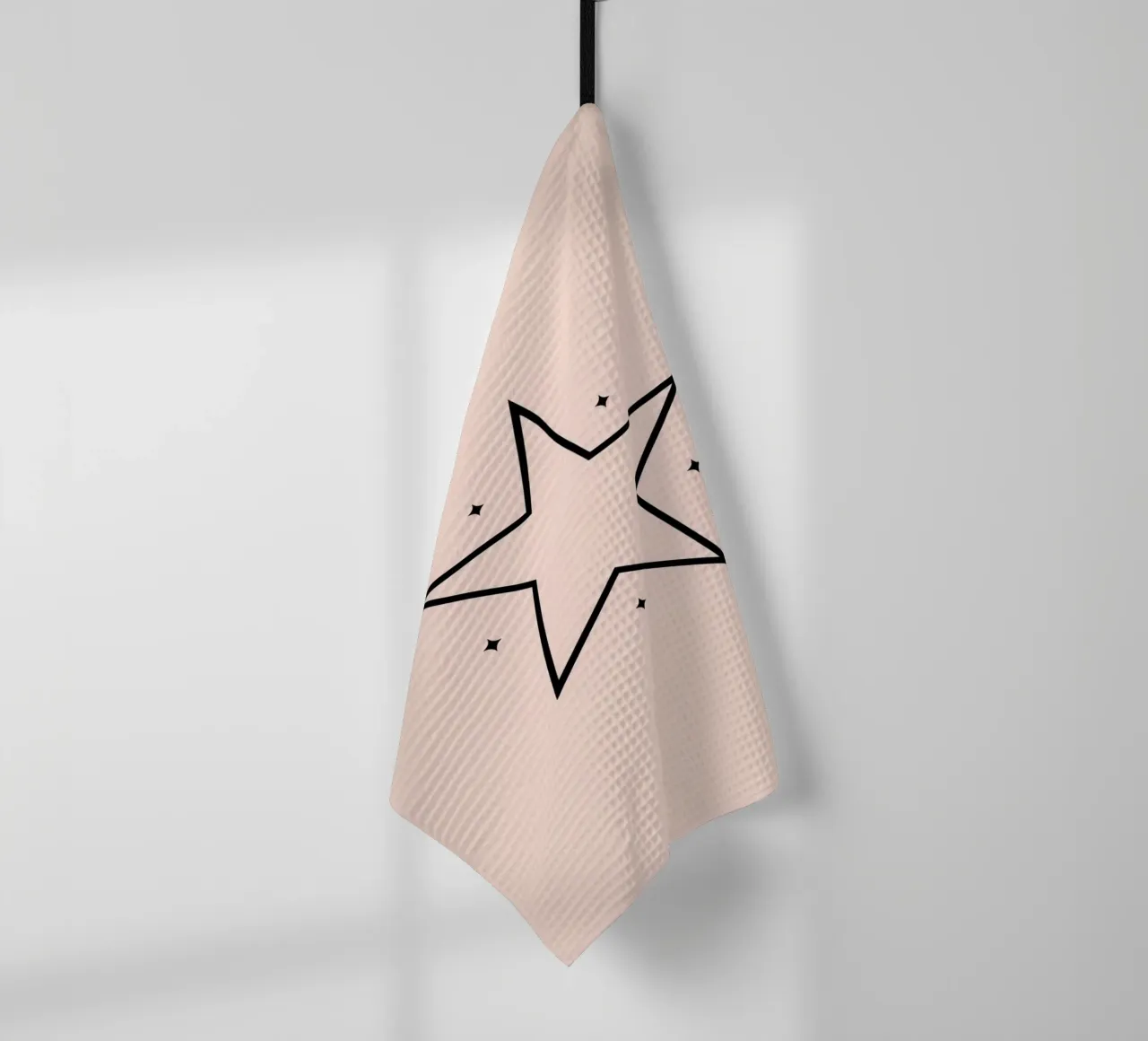 Minimalist black star design on a soft pink background tea towel by DesignDoodle