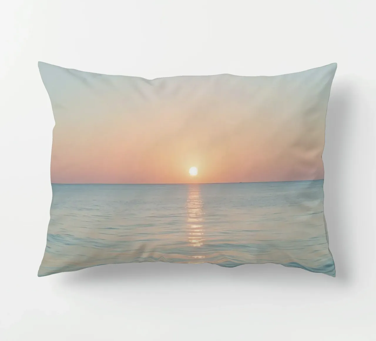 Sunset over calm ocean waters with pastel hues reflecting decorative cushion by DesignDoodle