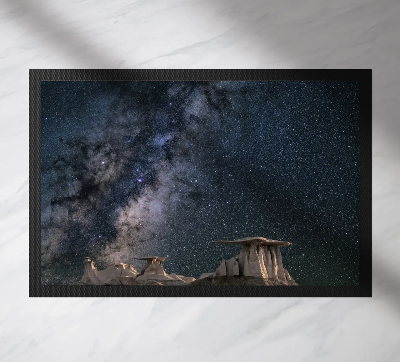 rock formations behind starry sky doormat by space words
