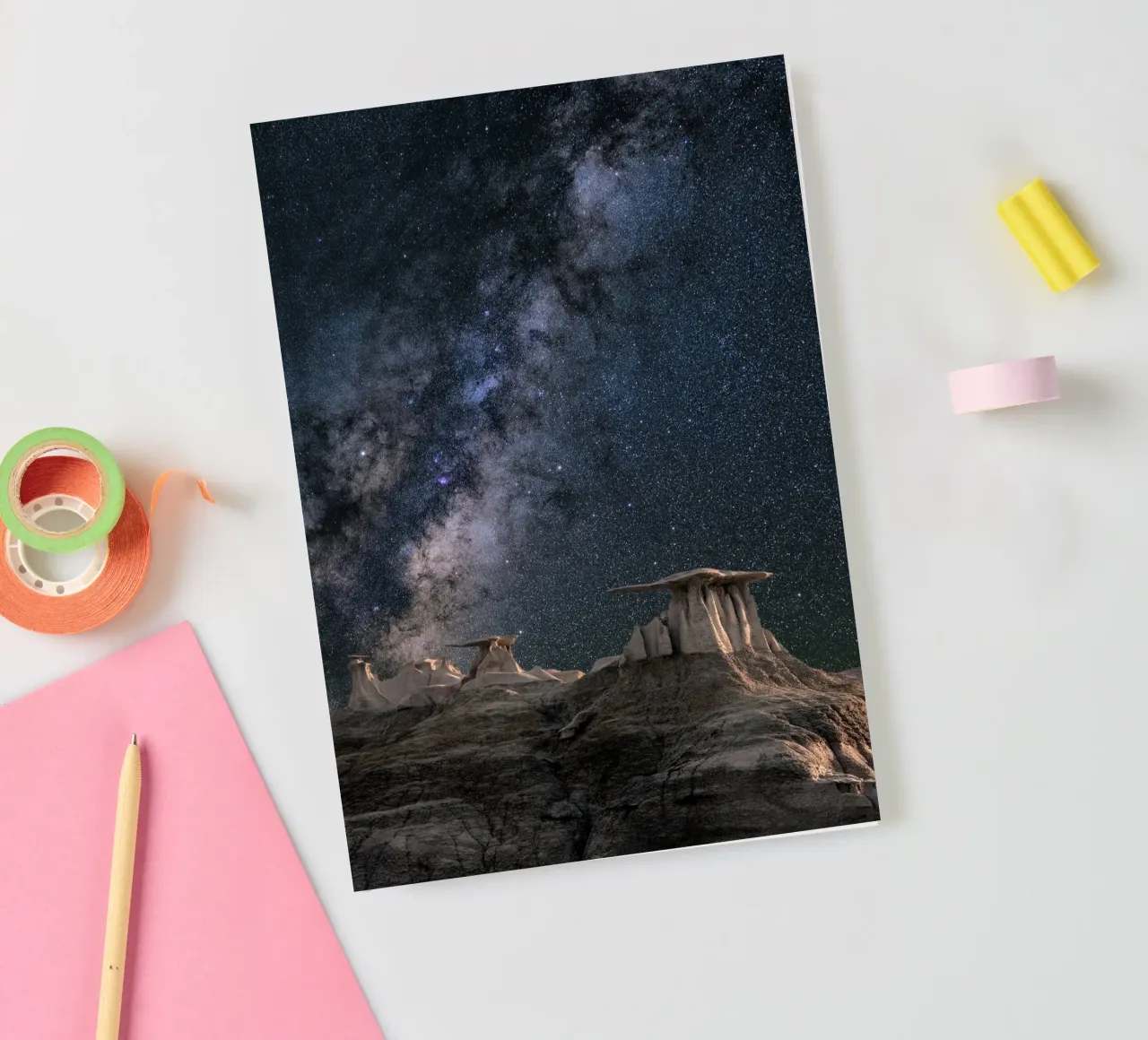 rock formations behind starry sky notebook by space words