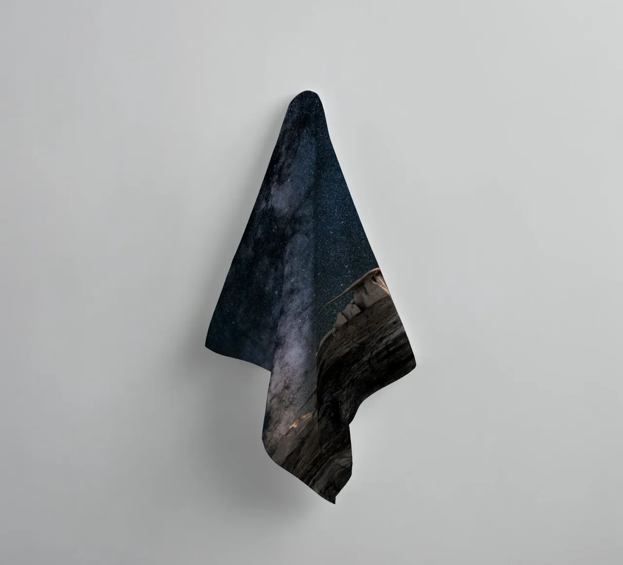 rock formations behind starry sky towel by space words