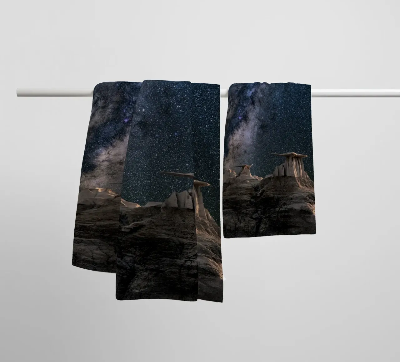 rock formations behind starry sky towel by space words