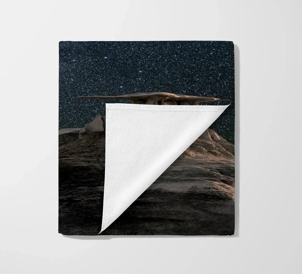 rock formations behind starry sky beach towel by space words