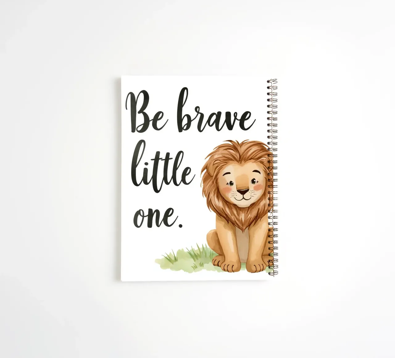 Be brave little one art with a cartoon lion sitting on grass spiral notebook by DesignDoodle