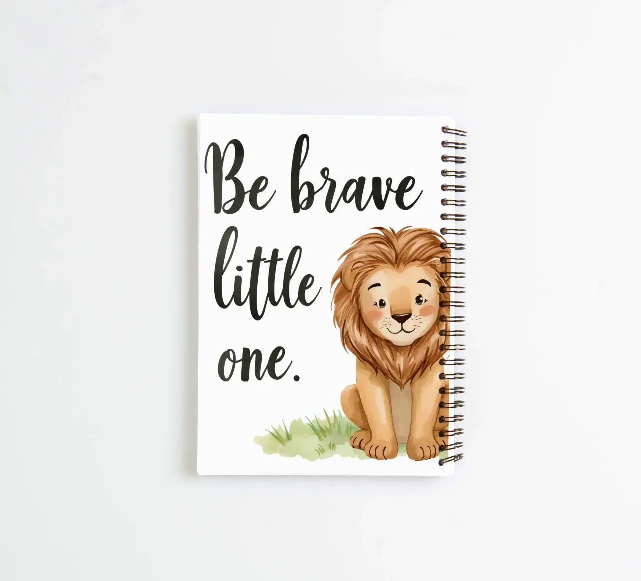 Be brave little one art with a cartoon lion sitting on grass spiral notebook by DesignDoodle