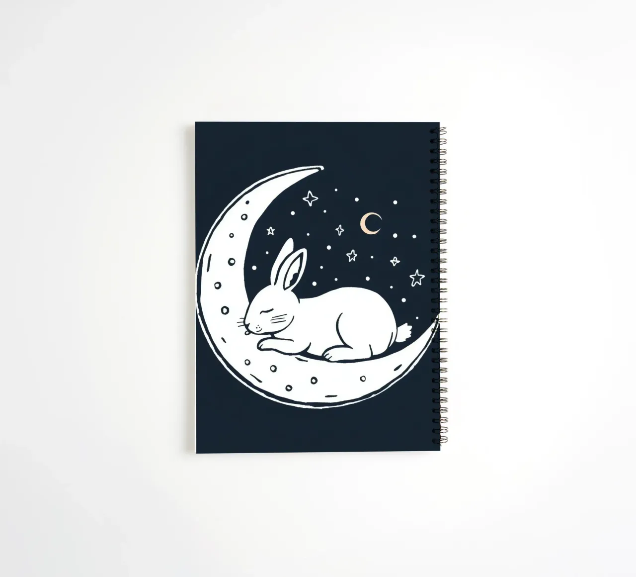 Sleeping bunny resting on crescent moon surrounded by stars spiral notebook by DesignDoodle