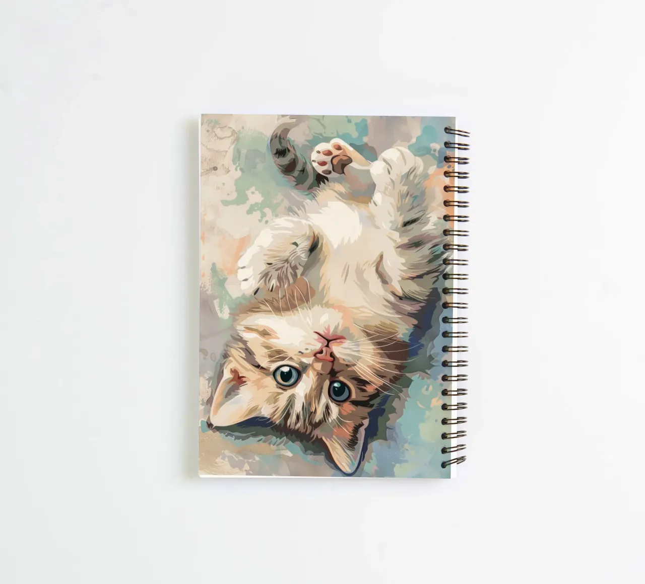 fluffy kitten with bright eyes, playfully lying on its back spiral notebook by DesignDoodle