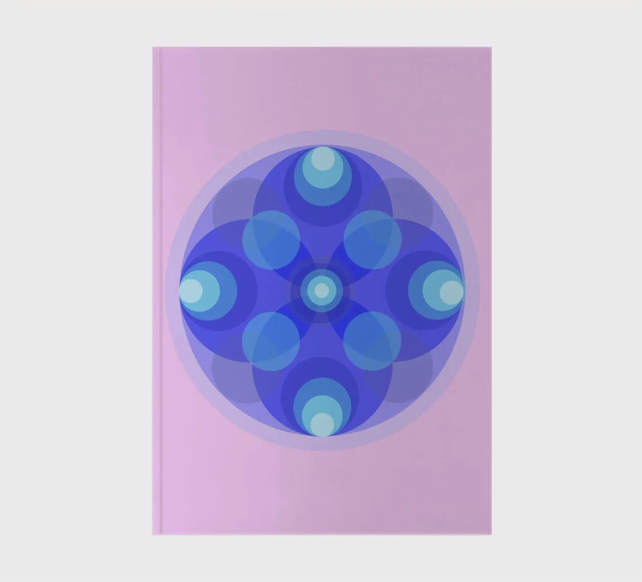 Blue abstract retro flower mandala in front of pink notebook by Lilou Art