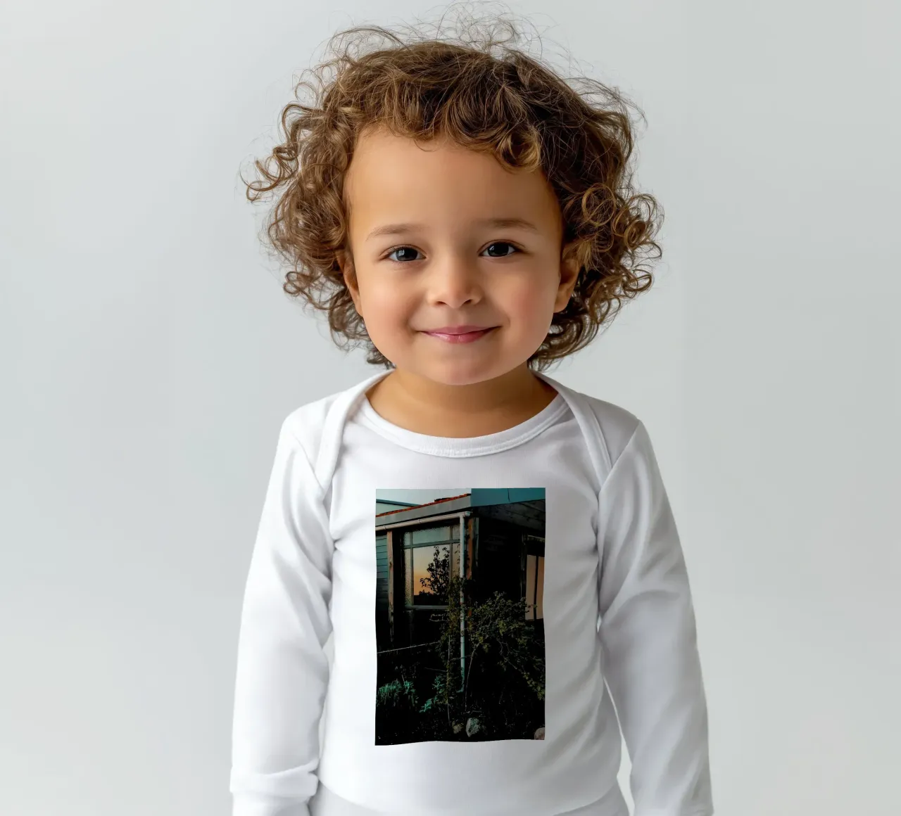 Sundown Secret Garden long-sleeve baby romper by Sebastian Hilgetag