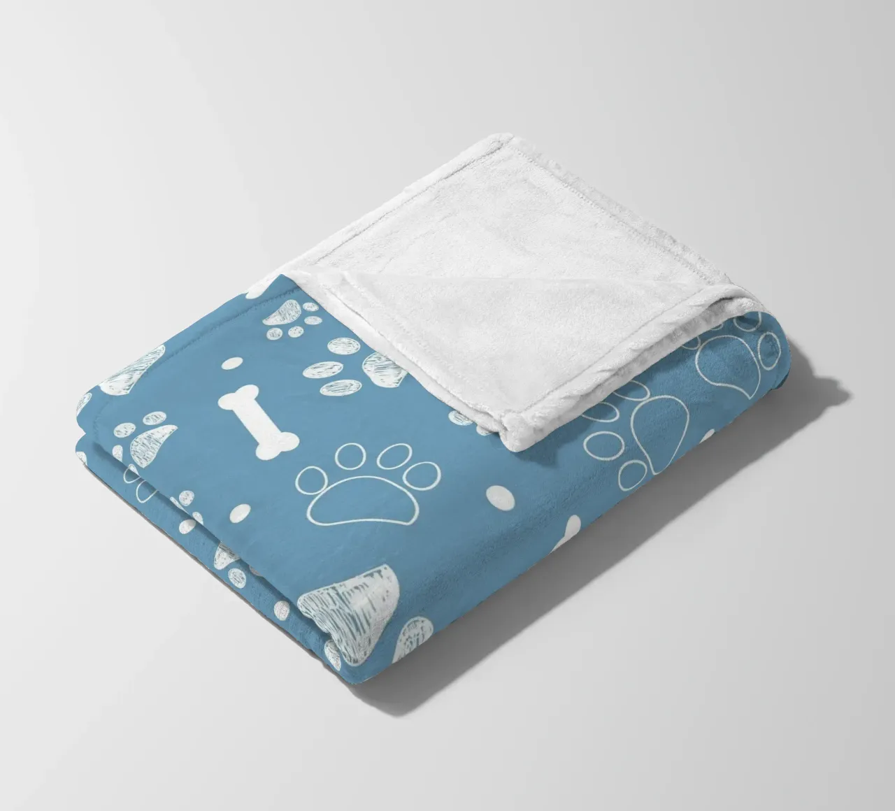 Sfondo navy con zampa e ossa bianche coperta in pile da gulsengunel