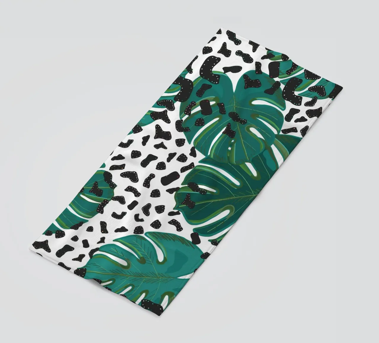 Monstera leaves with leopard print pattern beach towel by gulsengunel
