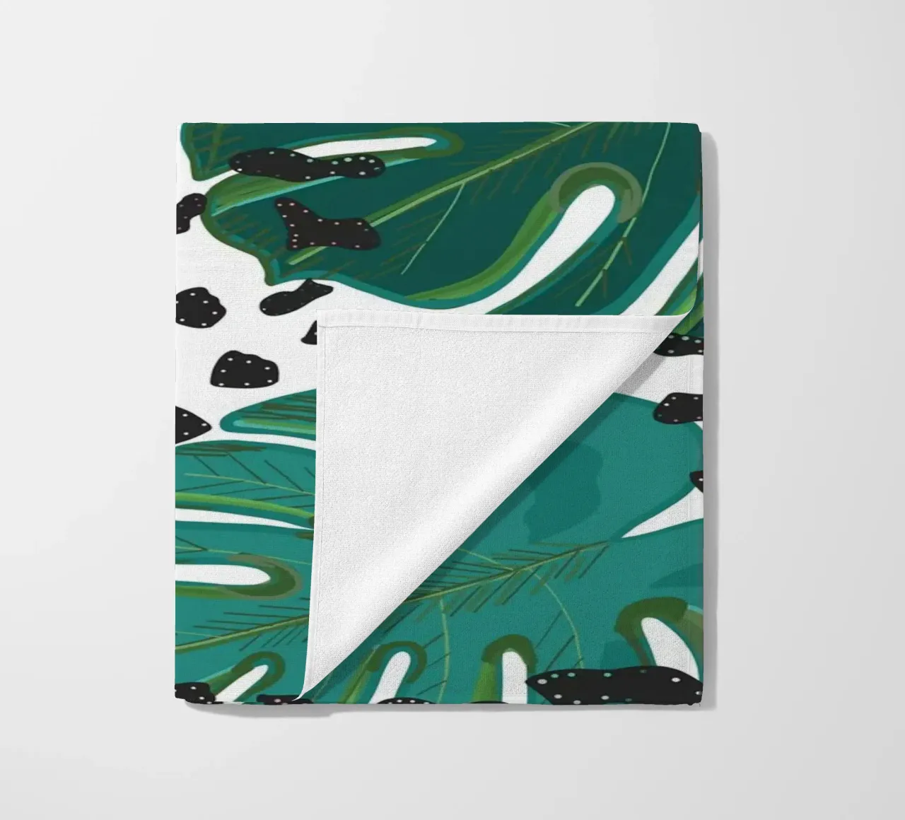 Monstera leaves with leopard print pattern beach towel by gulsengunel