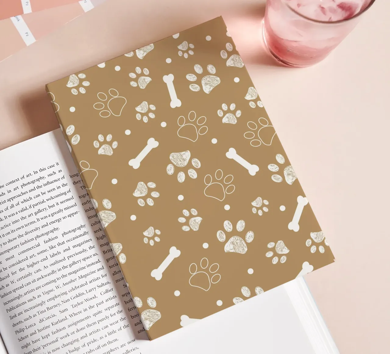 Light brown background with white paw and bones notebook by gulsengunel