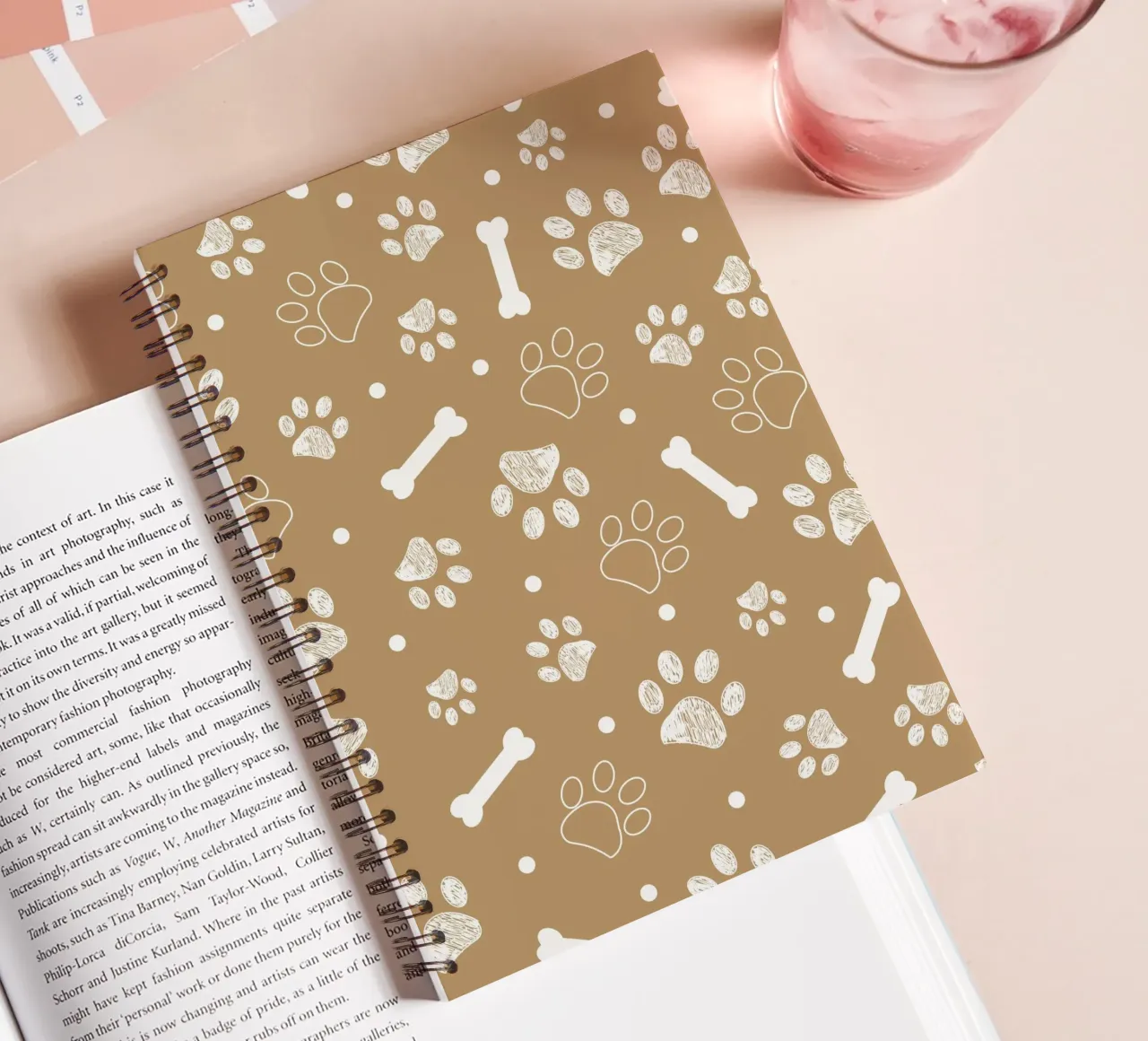 Light brown background with white paw and bones spiral notebook by gulsengunel