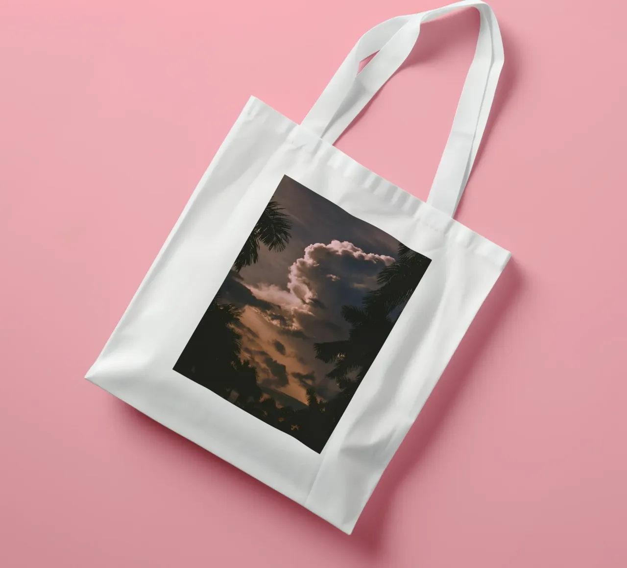 clouds in sunset with palm trees tote bag by home of clouds