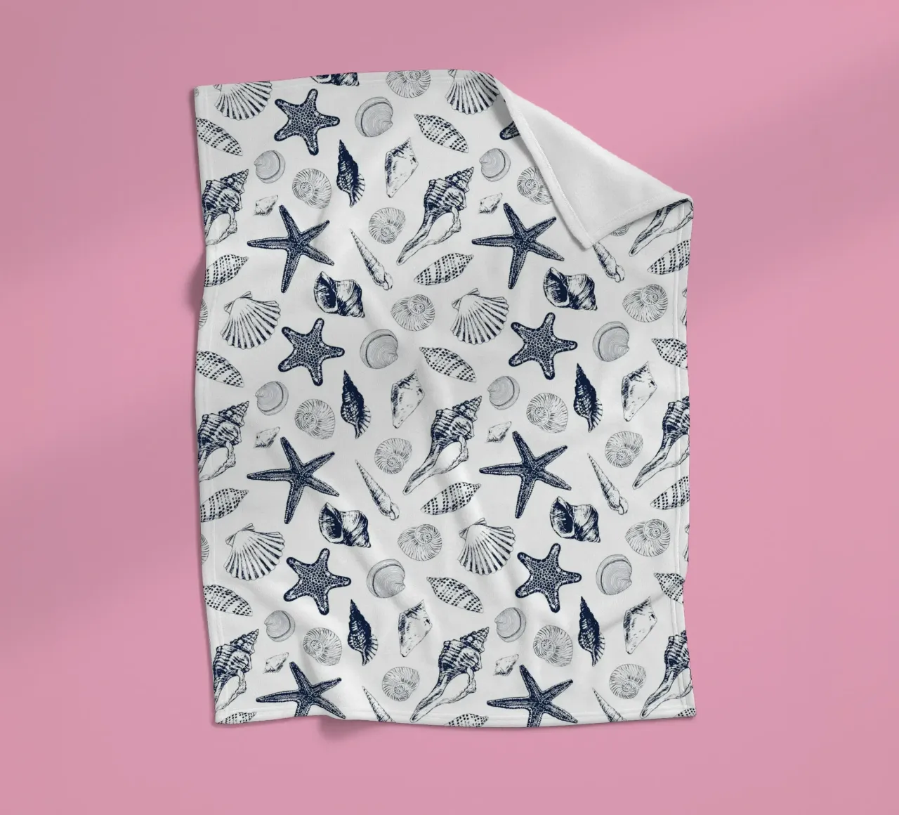 Sea shells in navy fleece blanket by Painted Nature