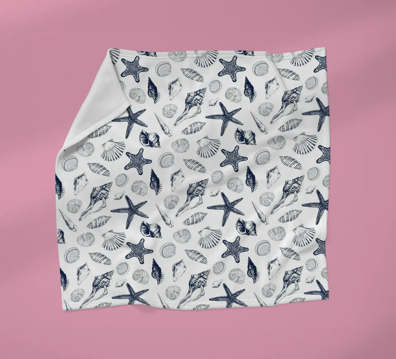 Sea shells in navy fleece blanket by Painted Nature