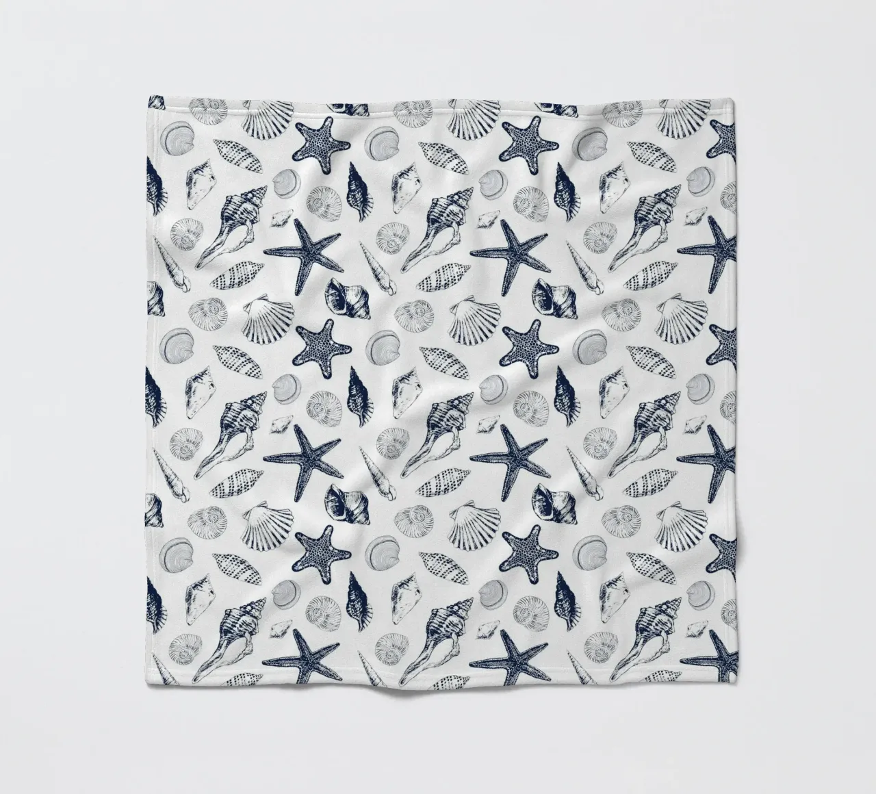 Sea shells in navy fleece blanket by Painted Nature