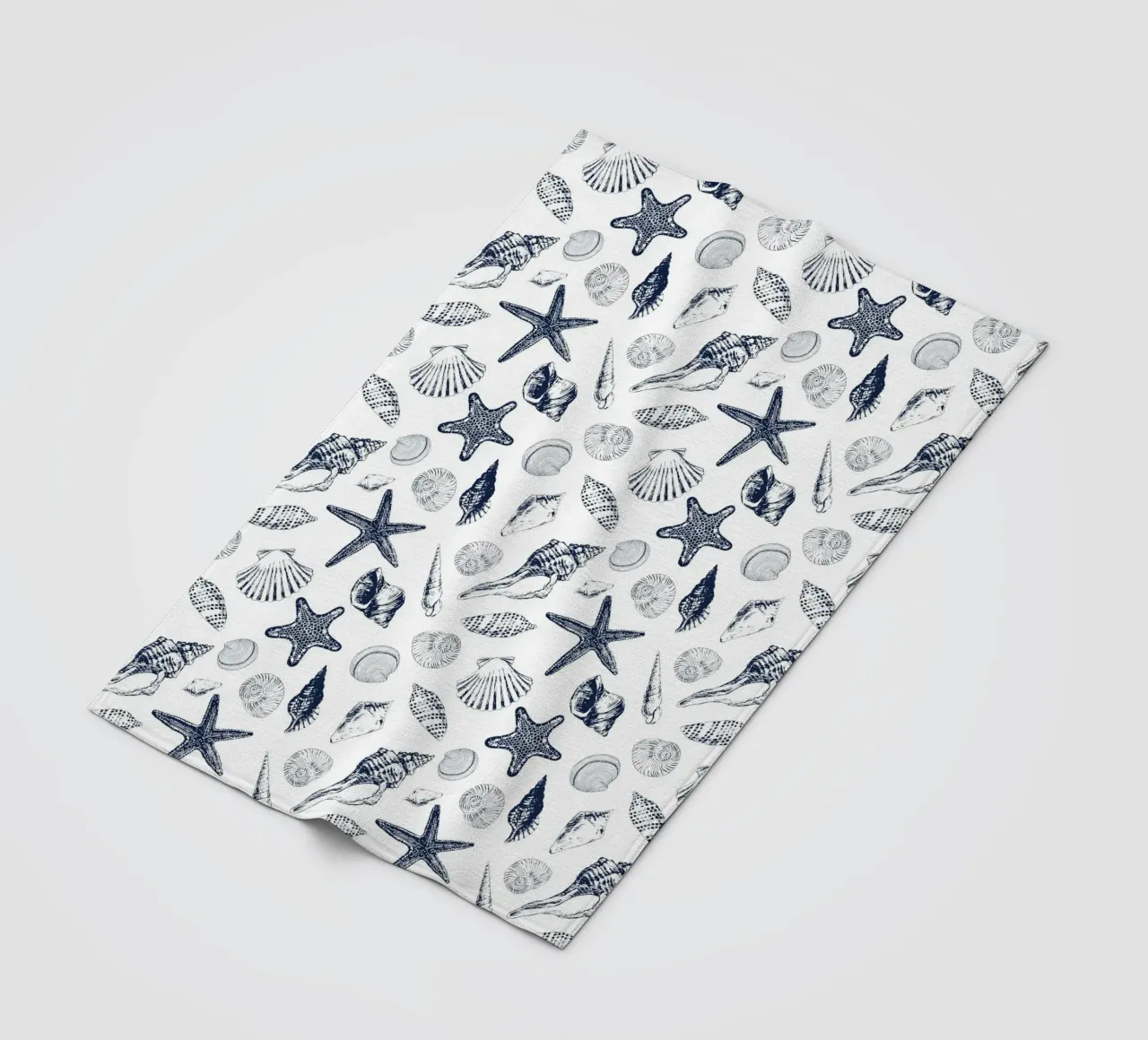 Sea shells in navy fleece blanket by Painted Nature