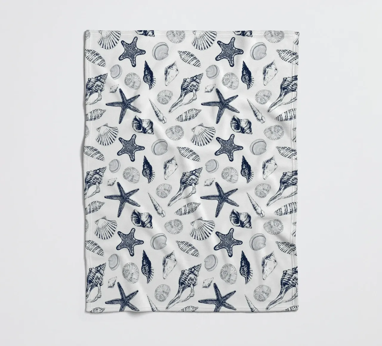 Sea shells in navy fleece blanket by Painted Nature
