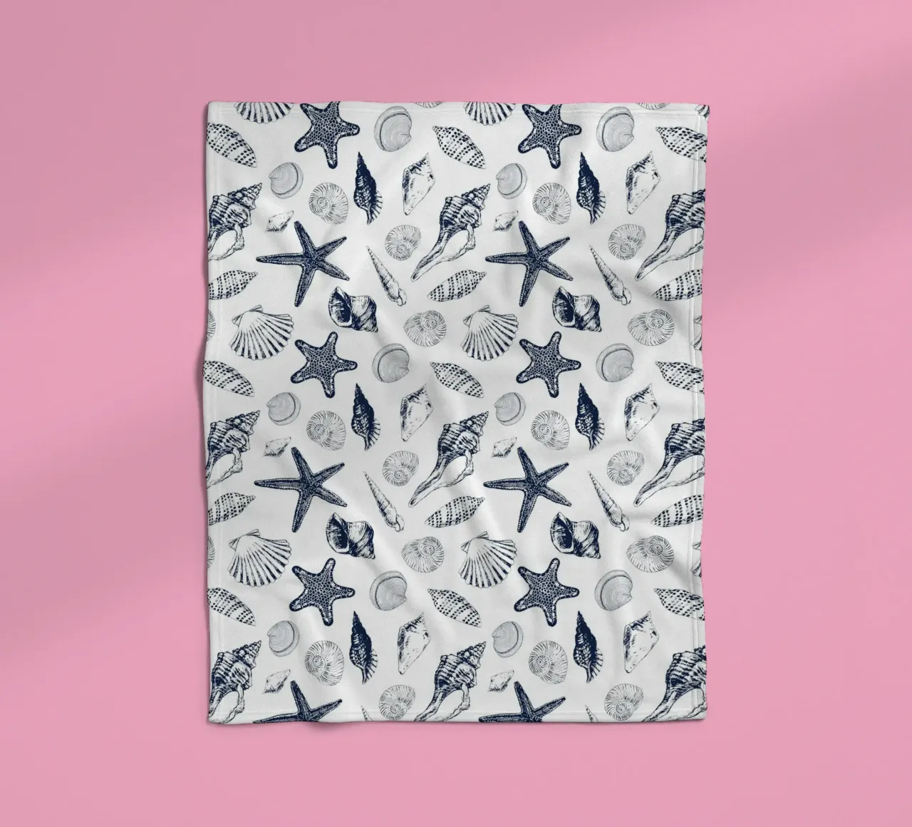 Sea shells in navy fleece blanket by Painted Nature
