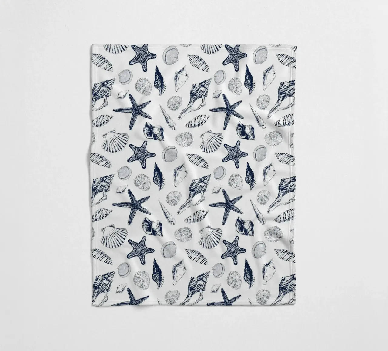 Sea shells in navy fleece blanket by Painted Nature