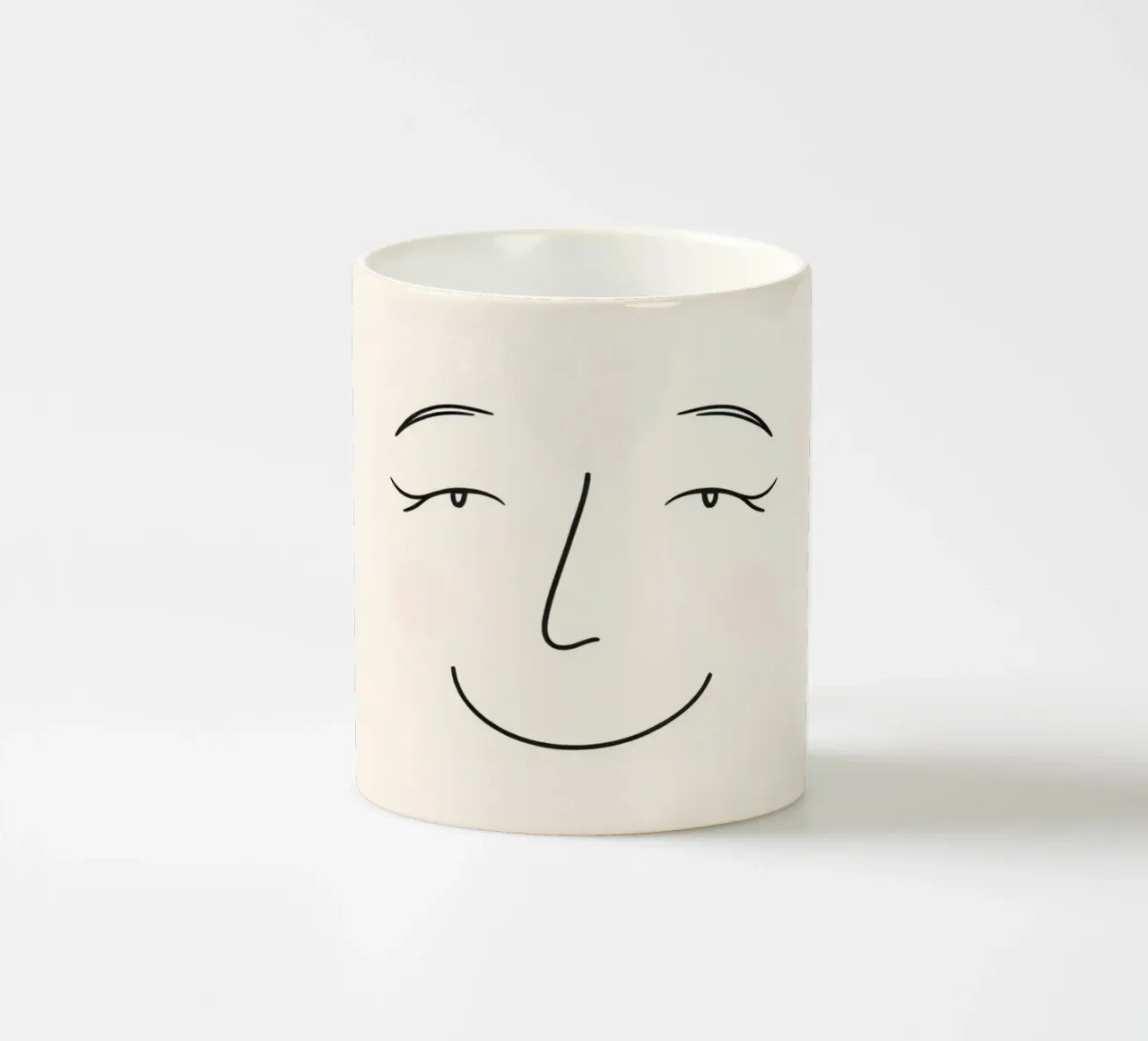 Simple line drawing shows a smiling face with blushed cheek ceramic mug by DesignDoodle