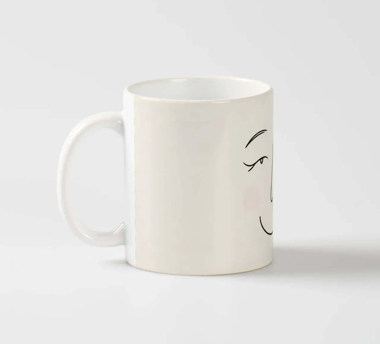 Simple line drawing shows a smiling face with blushed cheek ceramic mug by DesignDoodle