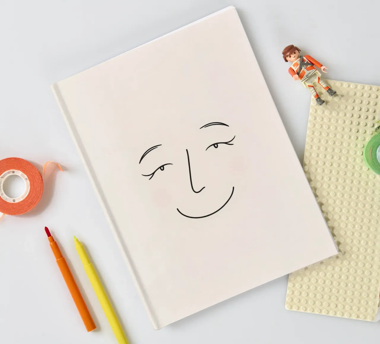 Simple line drawing shows a smiling face with blushed cheek notebook by DesignDoodle