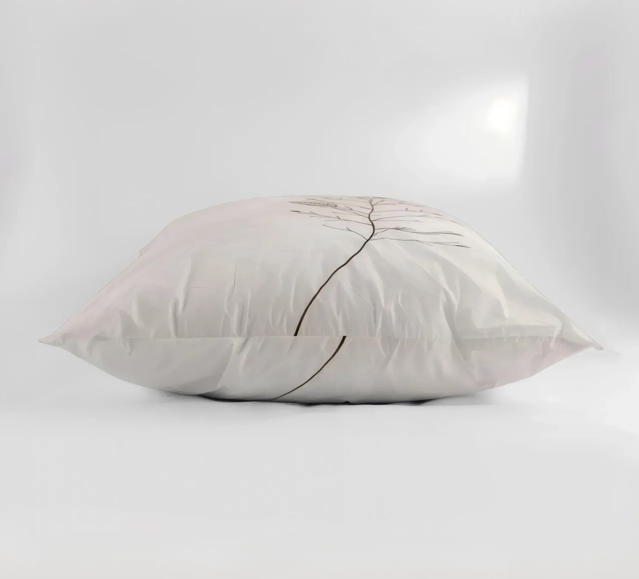 Single minimal botanical branch, displaying a leaf decorative cushion by DesignDoodle