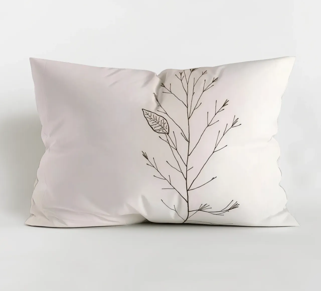 Single minimal botanical branch, displaying a leaf decorative cushion by DesignDoodle