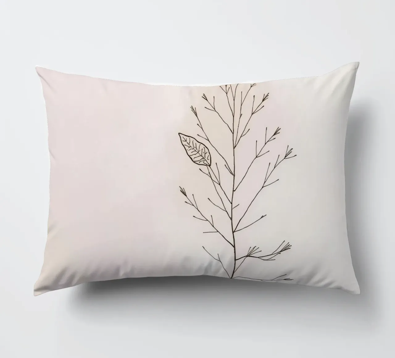 Single minimal botanical branch, displaying a leaf decorative cushion by DesignDoodle