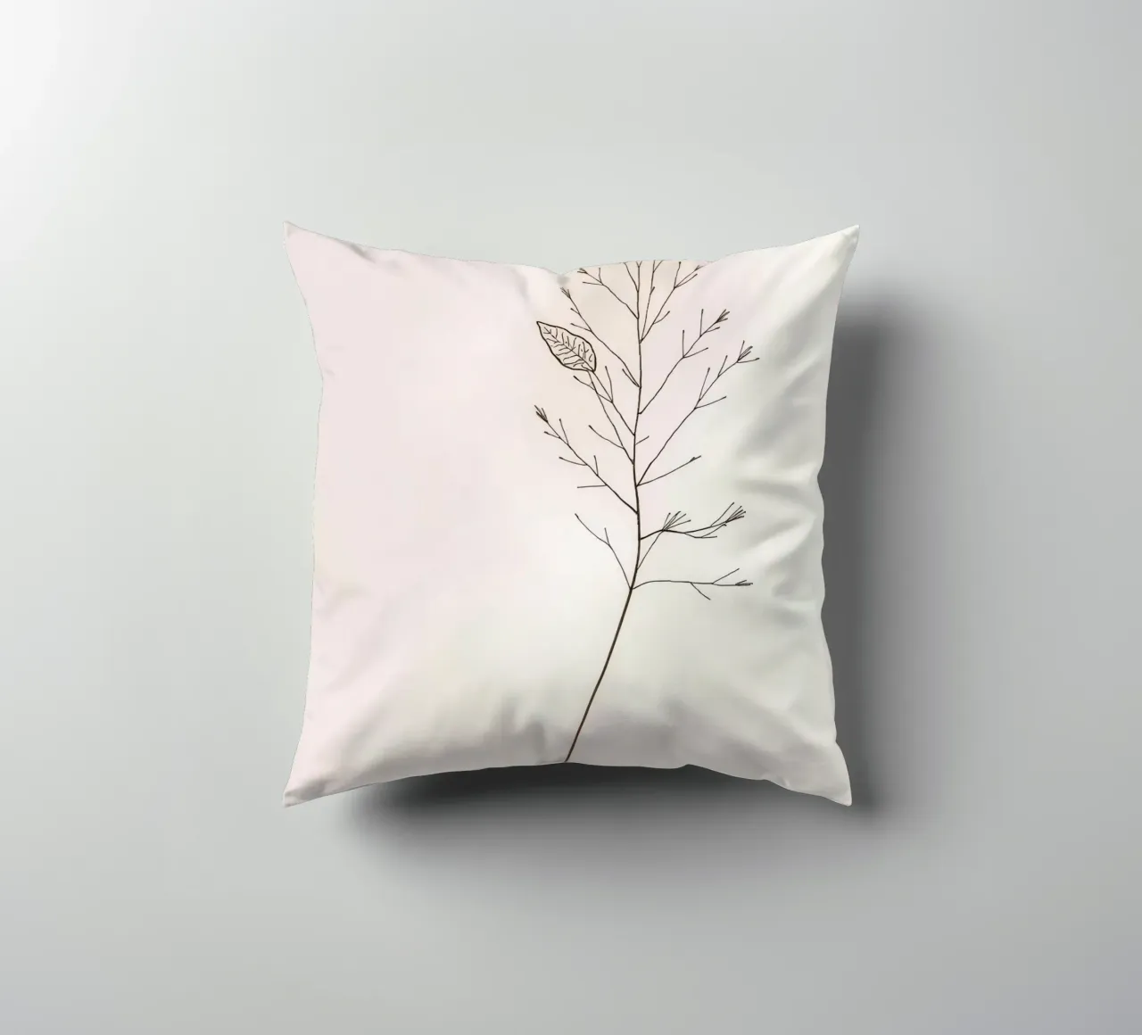 Single minimal botanical branch, displaying a leaf decorative cushion by DesignDoodle