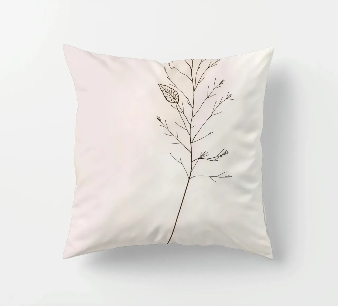 Single minimal botanical branch, displaying a leaf decorative cushion by DesignDoodle