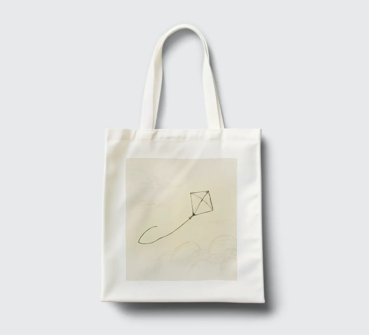 Kite soars high above the ground with sketched clouds tote bag by DesignDoodle