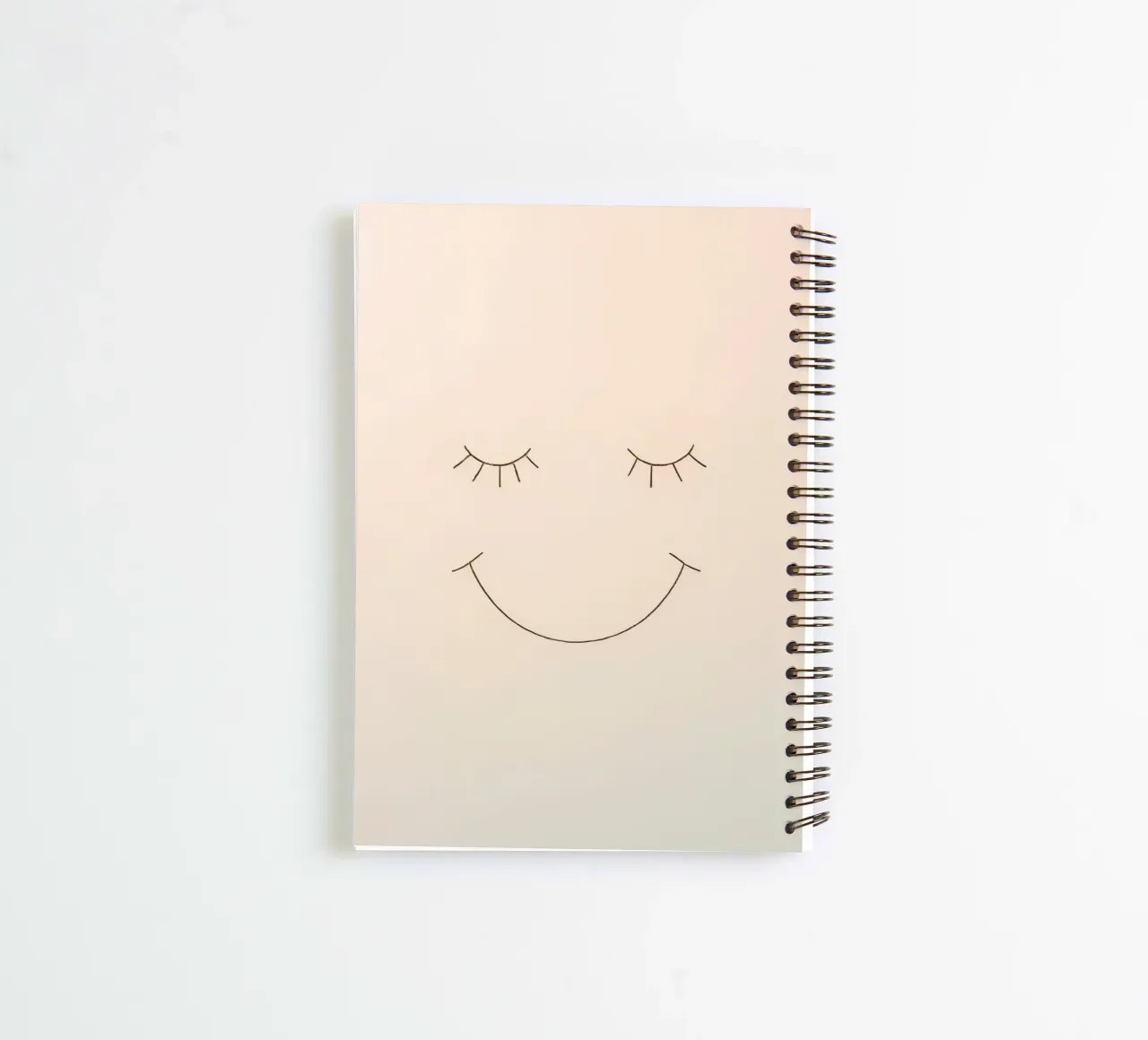 Simple drawing of a face with closed eyes and a smile spiral notebook by DesignDoodle