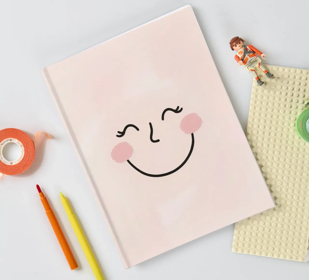 Happy face drawing on light pink background notebook by DesignDoodle