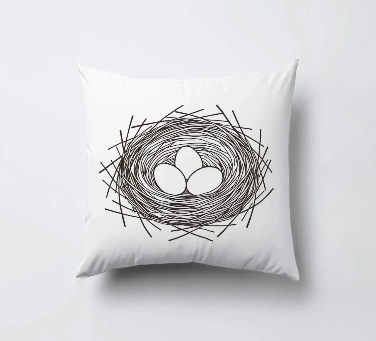 Nest containing three eggs depicted with line art decorative cushion by DesignDoodle